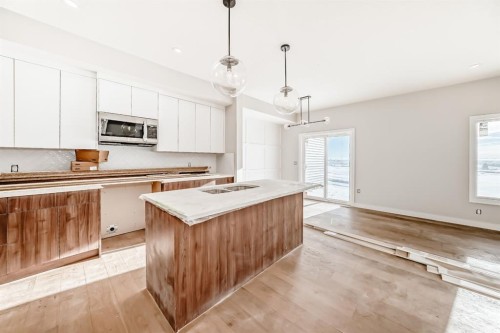 512 Heritage Boulevard, Cochrane, AB - Indoor Photo Showing Kitchen With Double Sink