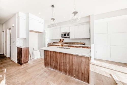 512 Heritage Boulevard, Cochrane, AB - Indoor Photo Showing Kitchen With Double Sink
