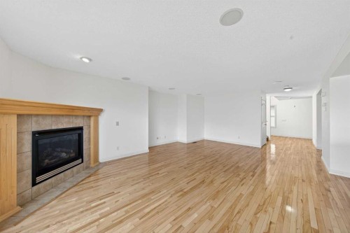 320 Everbrook Way Sw, Calgary, AB - Indoor Photo Showing Living Room With Fireplace