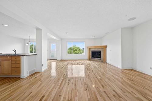 320 Everbrook Way Sw, Calgary, AB - Indoor Photo Showing Living Room With Fireplace