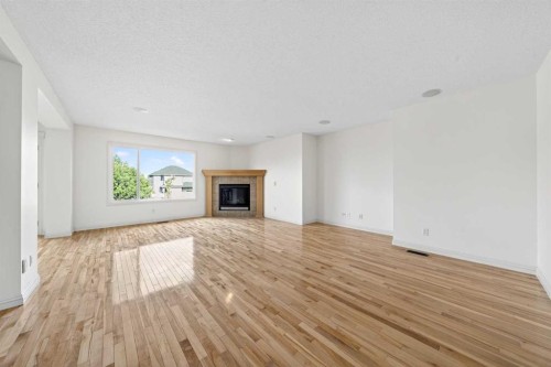 320 Everbrook Way Sw, Calgary, AB - Indoor Photo Showing Living Room With Fireplace