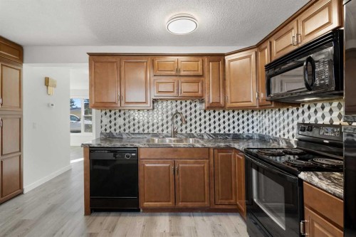 327 Abalone Place Ne, Calgary, AB - Indoor Photo Showing Kitchen With Double Sink