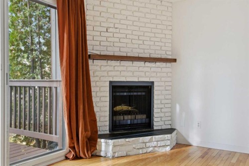 8-803 Varsity Estates Drive Nw, Calgary, AB - Indoor Photo Showing Living Room With Fireplace
