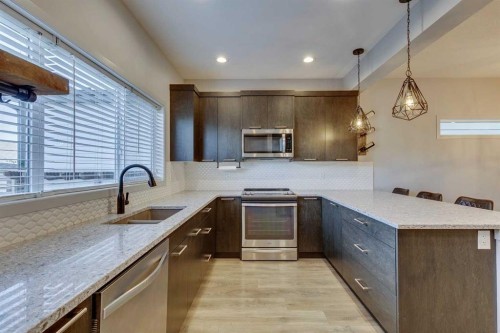 144 Masters Link Se, Calgary, AB - Indoor Photo Showing Kitchen With Stainless Steel Kitchen With Double Sink With Upgraded Kitchen