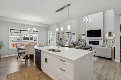 504 Creekrun Lane Sw, Airdrie, AB - Indoor Photo Showing Kitchen With Fireplace With Double Sink