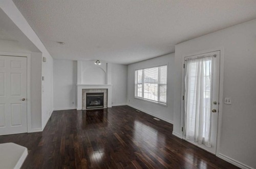 217 Somerside Close Sw, Calgary, AB - Indoor Photo Showing Living Room With Fireplace
