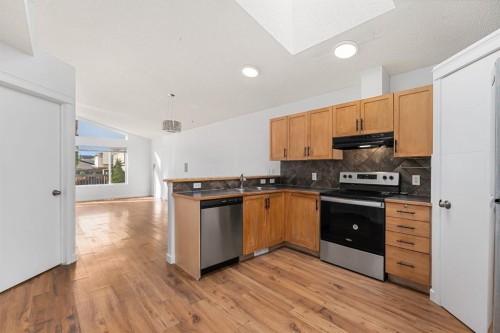 203 Prestwick Heights Se, Calgary, AB - Indoor Photo Showing Kitchen With Double Sink