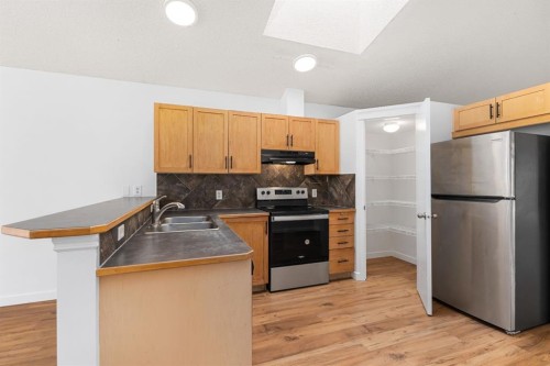 203 Prestwick Heights Se, Calgary, AB - Indoor Photo Showing Kitchen With Double Sink