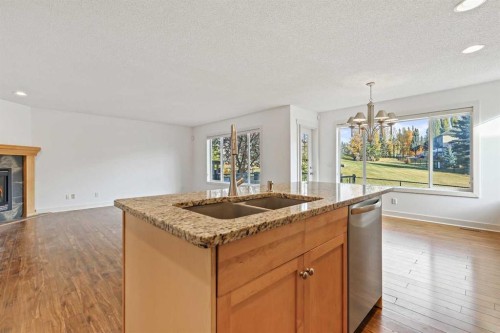 7936 Springbank Boulevard Sw, Calgary, AB - Indoor Photo Showing Kitchen With Fireplace With Double Sink