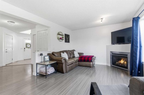 74 Evansbrooke Way Nw, Calgary, AB - Indoor Photo Showing Living Room With Fireplace
