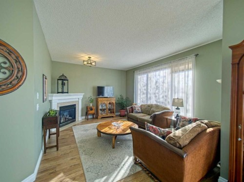 239 Sagewood Drive, Airdrie, AB - Indoor Photo Showing Living Room With Fireplace