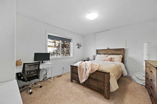 129 Springbluff Boulevard Sw, Calgary, AB - Indoor Photo Showing Bedroom
