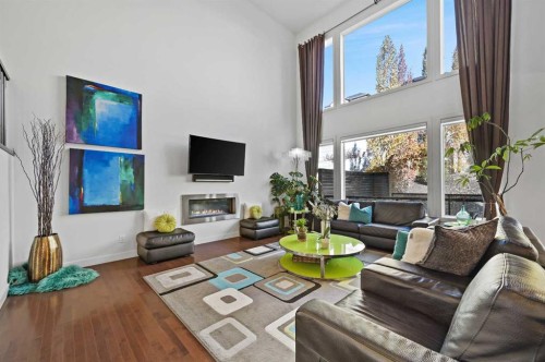129 Springbluff Boulevard Sw, Calgary, AB - Indoor Photo Showing Living Room With Fireplace