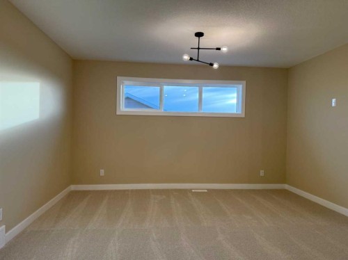 72 Sunrise Heath, Cochrane, AB - Indoor Photo Showing Other Room