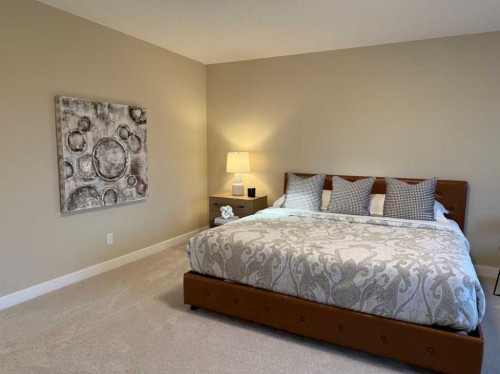 72 Sunrise Heath, Cochrane, AB - Indoor Photo Showing Bedroom