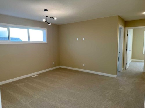 72 Sunrise Heath, Cochrane, AB - Indoor Photo Showing Other Room