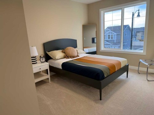 72 Sunrise Heath, Cochrane, AB - Indoor Photo Showing Bedroom