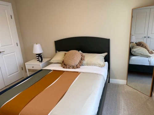 72 Sunrise Heath, Cochrane, AB - Indoor Photo Showing Bedroom