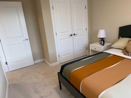 72 Sunrise Heath, Cochrane, AB - Indoor Photo Showing Bedroom