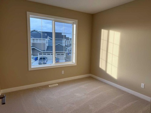 72 Sunrise Heath, Cochrane, AB - Indoor Photo Showing Other Room