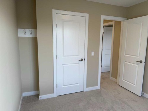 72 Sunrise Heath, Cochrane, AB - Indoor Photo Showing Other Room