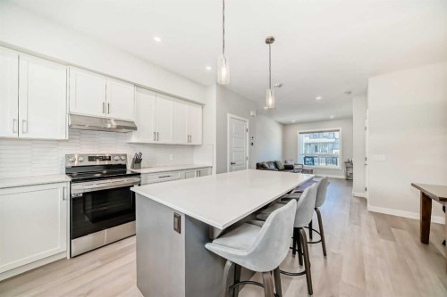 934 Cobblemore Common Sw, Airdrie, AB - Indoor Photo Showing Kitchen With Stainless Steel Kitchen With Upgraded Kitchen