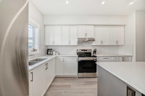 934 Cobblemore Common Sw, Airdrie, AB - Indoor Photo Showing Kitchen With Double Sink