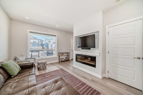 934 Cobblemore Common Sw, Airdrie, AB - Indoor Photo Showing Living Room With Fireplace
