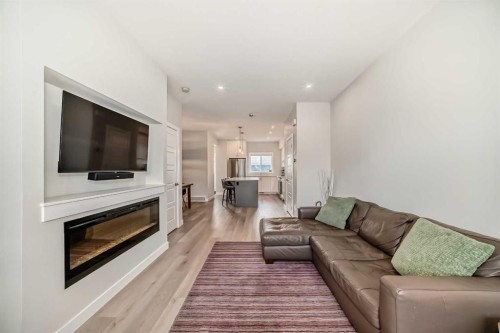 934 Cobblemore Common Sw, Airdrie, AB - Indoor Photo Showing Living Room With Fireplace