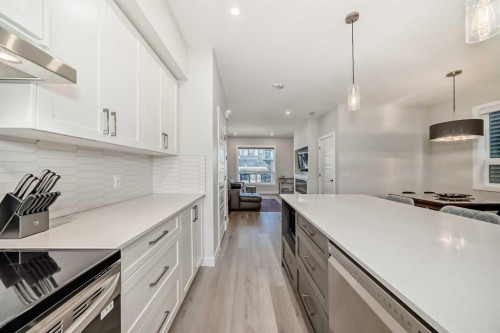 934 Cobblemore Common Sw, Airdrie, AB - Indoor Photo Showing Kitchen With Stainless Steel Kitchen With Upgraded Kitchen