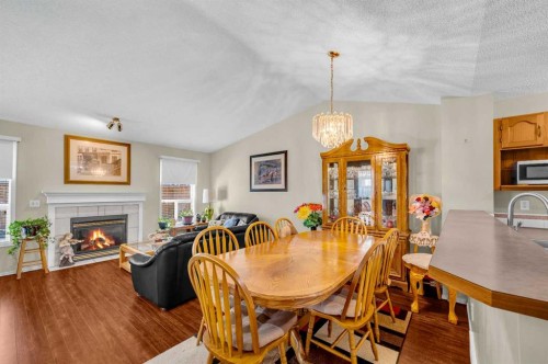 65 Tararidge Circle Ne, Calgary, AB - Indoor Photo Showing Dining Room With Fireplace