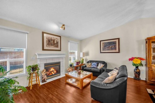 65 Tararidge Circle Ne, Calgary, AB - Indoor Photo Showing Living Room With Fireplace