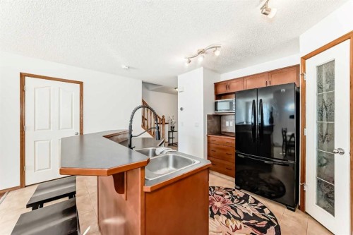 201 Cranberry Square Se, Calgary, AB - Indoor Photo Showing Kitchen With Double Sink