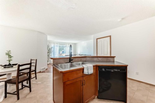 201 Cranberry Square Se, Calgary, AB - Indoor Photo Showing Kitchen With Double Sink