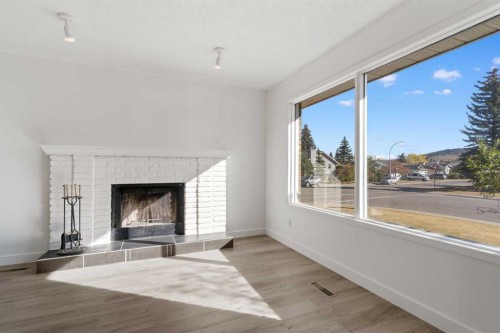 2 West Barrett Place, Cochrane, AB - Indoor Photo Showing Living Room With Fireplace