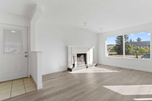2 West Barrett Place, Cochrane, AB - Indoor With Fireplace