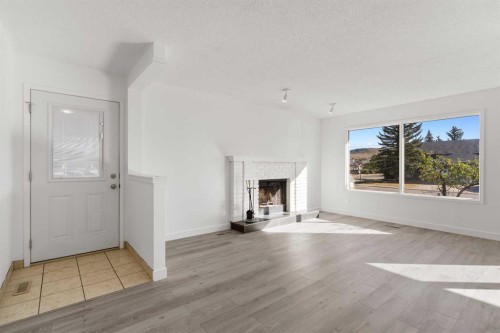 2 West Barrett Place, Cochrane, AB - Indoor Photo Showing Living Room With Fireplace