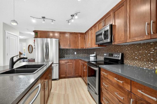 1346 Kings Heights Way Se, Airdrie, AB - Indoor Photo Showing Kitchen With Double Sink With Upgraded Kitchen