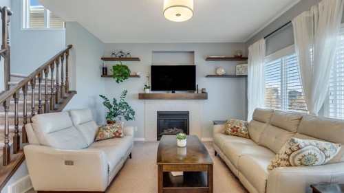 343 Hillcrest Heights Sw, Airdrie, AB - Indoor Photo Showing Living Room With Fireplace