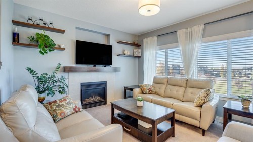 343 Hillcrest Heights Sw, Airdrie, AB - Indoor Photo Showing Living Room With Fireplace