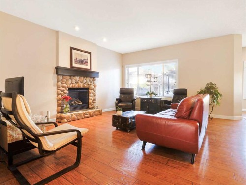 50 Elgin Meadows Green Se, Calgary, AB - Indoor Photo Showing Living Room With Fireplace