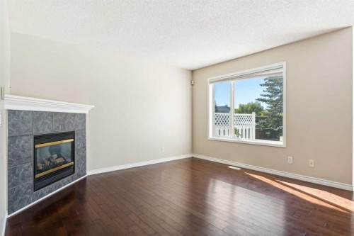 73 Rocky Ridge Heath Nw, Calgary, AB - Indoor Photo Showing Other Room With Fireplace
