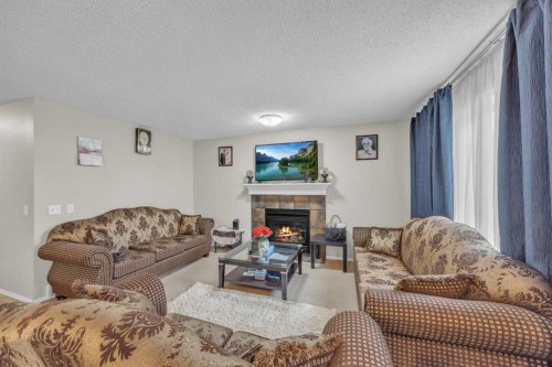 814 Copperfield Boulevard Se, Calgary, AB - Indoor Photo Showing Living Room With Fireplace