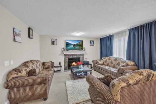 814 Copperfield Boulevard Se, Calgary, AB - Indoor Photo Showing Living Room With Fireplace