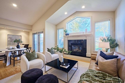 250 Strathridge Place Sw, Calgary, AB - Indoor Photo Showing Living Room With Fireplace