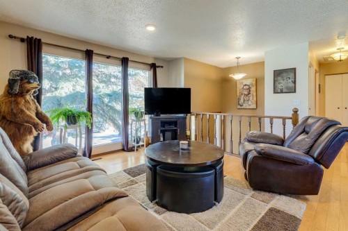 150 Midcrest Crescent Se, Calgary, AB - Indoor Photo Showing Living Room With Fireplace