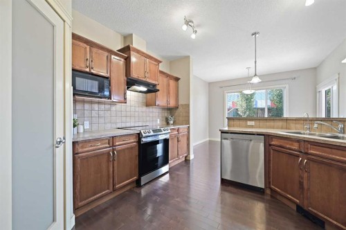 229 Bridlerange Place Sw, Calgary, AB - Indoor Photo Showing Kitchen With Double Sink With Upgraded Kitchen