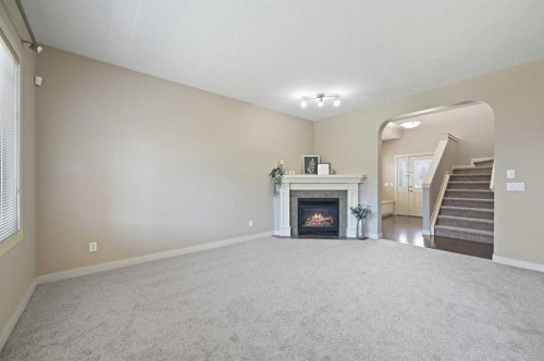 229 Bridlerange Place Sw, Calgary, AB - Indoor Photo Showing Other Room With Fireplace