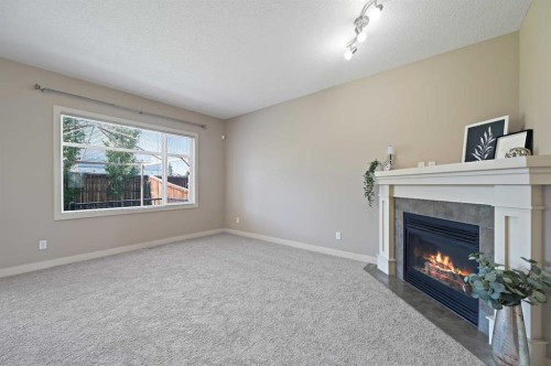 229 Bridlerange Place Sw, Calgary, AB - Indoor Photo Showing Living Room With Fireplace