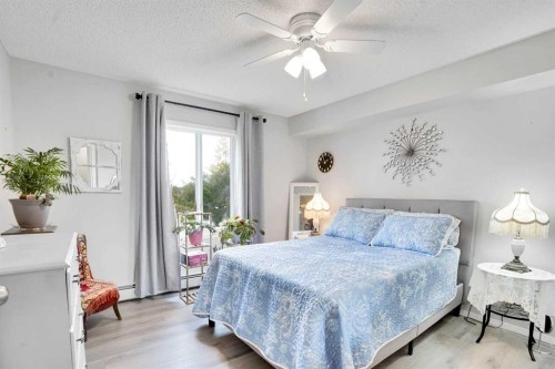 6211-304 Mackenzie Way Sw, Airdrie, AB - Indoor Photo Showing Bedroom